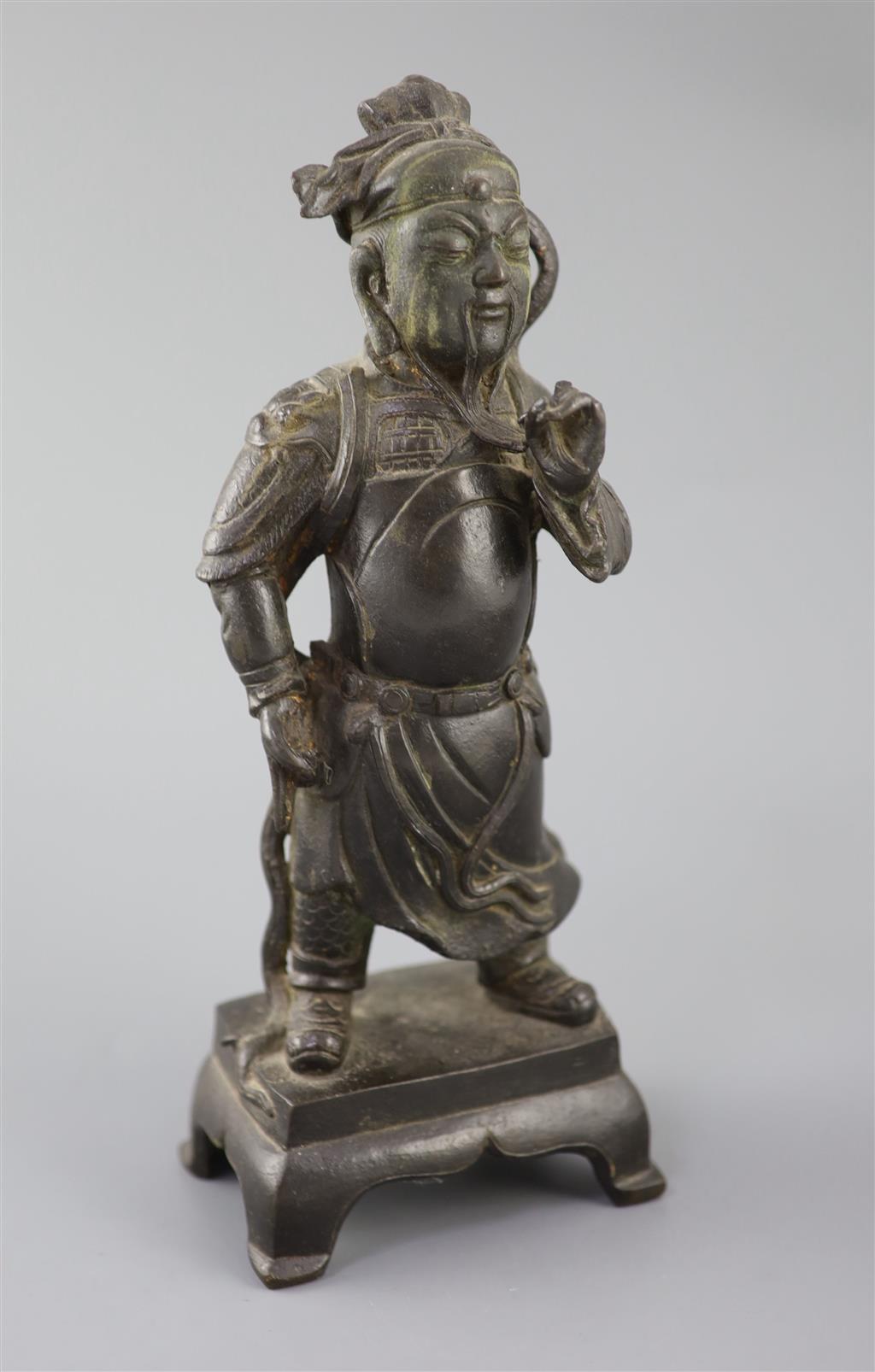 A Chinese bronze standing figure of Guandi, 16th/17th century, 31cm high, small losses